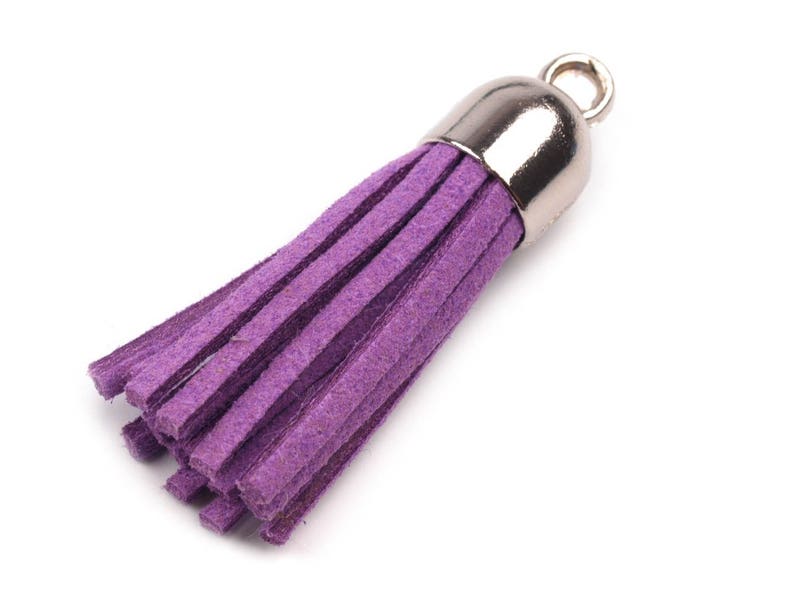 May include: A purple suede tassel with a silver metal top. The tassel is about 2 inches long.