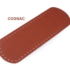 May include: A cognac brown leather strap with evenly spaced holes for stitching. The strap is rectangular with rounded edges.