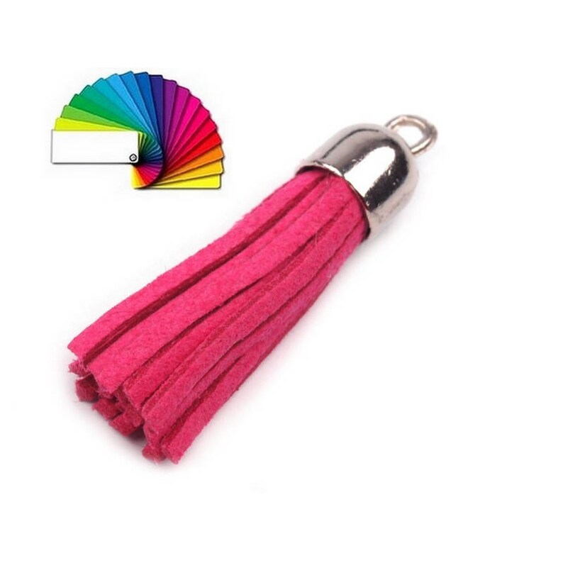 May include: A bright pink tassel with a silver metal top. The tassel is made of soft, fluffy material and is perfect for adding a touch of color and texture to any project.