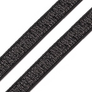 May include: Two black elastic bands with a sparkly silver texture. The bands are angled diagonally across a white background. The bands are likely used for sewing or crafting projects.