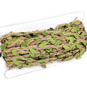 May include: A roll of brown hessian twine with green fabric leaves woven throughout. The twine is wrapped around a cardboard spool.
