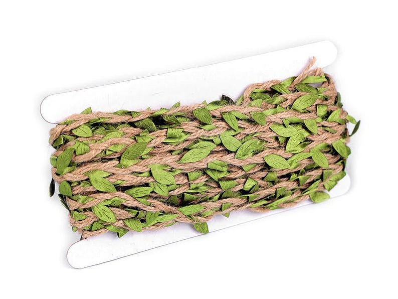 May include: A roll of brown hessian twine with green fabric leaves woven throughout. The twine is wrapped around a cardboard spool.