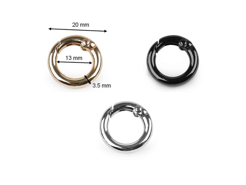 May include: Three metal key rings in gold, silver, and black. Each ring is 13 mm in diameter and 3.5 mm wide.