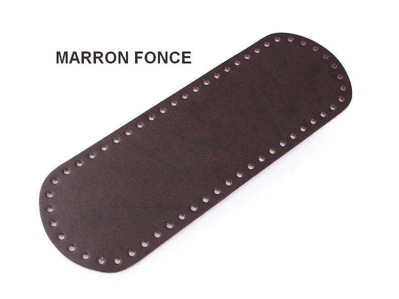May include: A brown leather strap with holes around the edges. The text "MARRON FONCE" is printed on the strap.