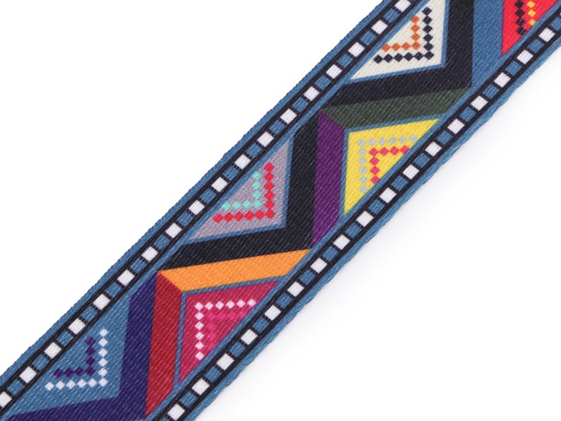 May include: Blue, red, yellow, green, and purple geometric patterned ribbon with a white and black border.