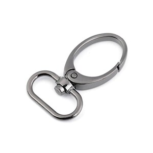 May include: A black metal swivel hook with a D-ring. The hook is designed for attaching to bags, keychains, or other items.