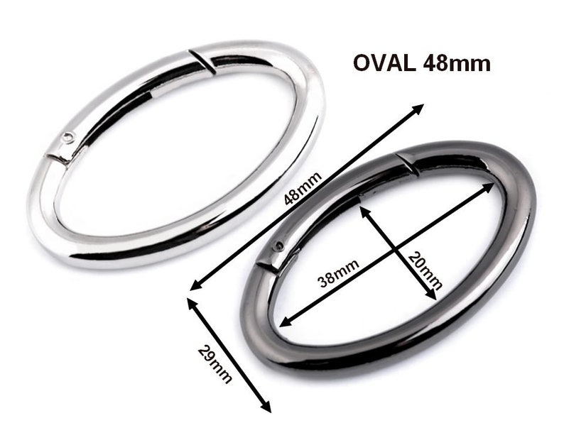 May include: Two oval-shaped metal clasps, one silver and one black. The silver clasp is 48 mm long and the black clasp is 48 mm long, 20 mm wide, and 29 mm high.  OVAL 48mm.