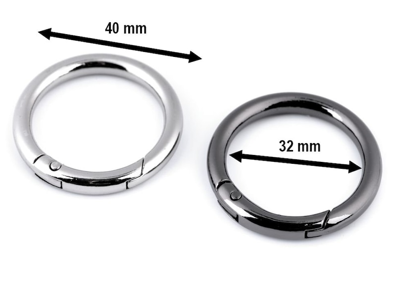 May include: Two metal key rings, one silver and one black. The silver ring is 40 mm in diameter and the black ring is 32 mm in diameter.