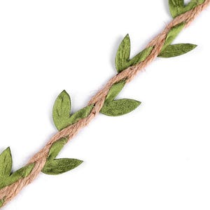 May include: A close-up of a brown jute twine with green fabric leaves attached. The twine is twisted and the leaves are arranged in a repeating pattern.