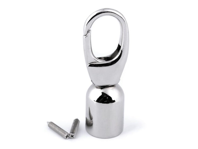 May include: Silver swivel hook with a round base and two screws. The hook is designed for attaching to a bag or other object.
