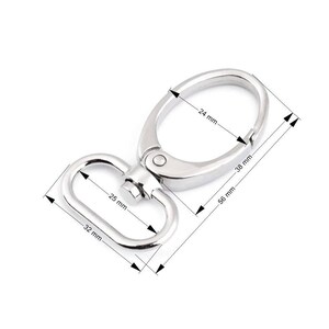 May include: Silver swivel trigger snap hook with a 24 mm diameter ring and a 32 mm long, 25 mm wide D-ring. The hook measures 56 mm long and 38 mm wide.