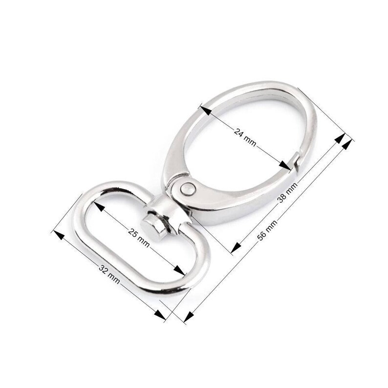May include: Silver swivel trigger snap hook with a 24 mm diameter ring and a 32 mm long, 25 mm wide D-ring. The hook measures 56 mm long and 38 mm wide.