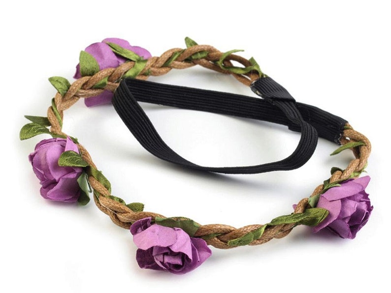 May include: A purple flower crown headband with a brown braided rope base and an elastic band.