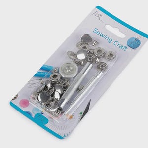 May include: A package of sewing craft supplies, including silver snap fasteners and two silver tools. The package has a blue and white design with the words "Sewing Craft" printed on it. A spool of blue thread is also shown.