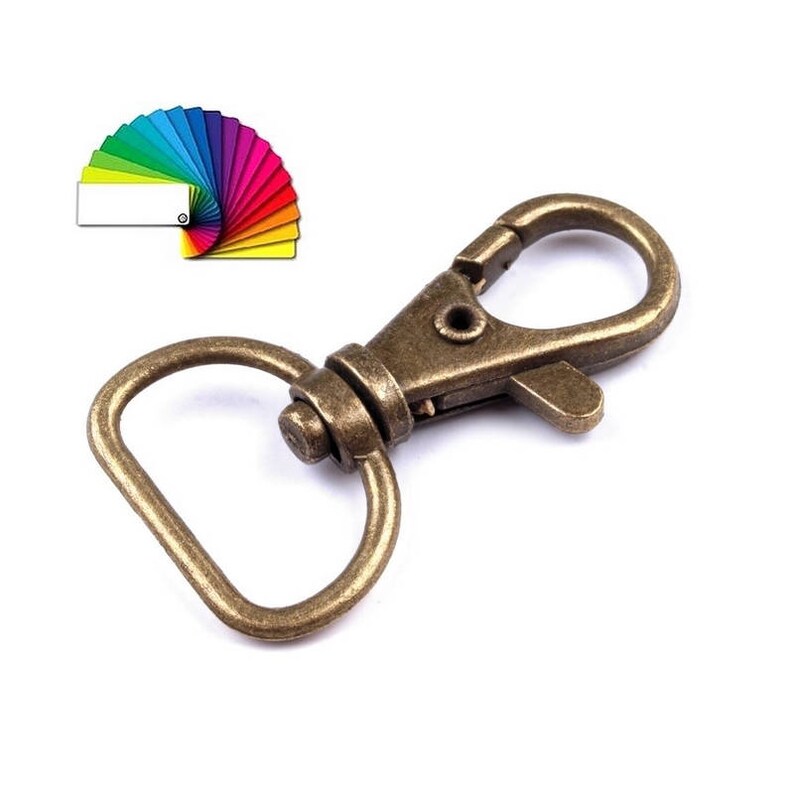 May include: Antique gold swivel lobster clasp with a D-ring. The clasp is made of metal and has a shiny finish.