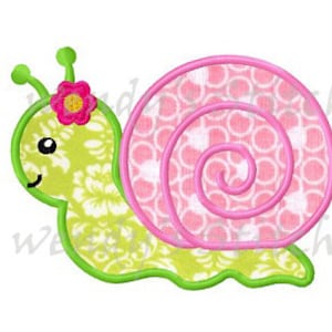 May include: A green snail with a pink shell and a pink flower on its head. The snail is smiling and has a white and green floral pattern on its body.