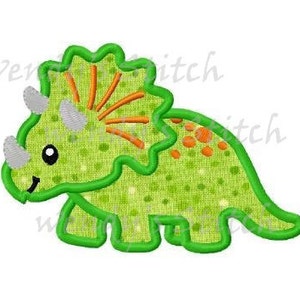 May include: Green felt applique of a cartoon triceratops with orange and white details. The dinosaur has a friendly face and three horns.