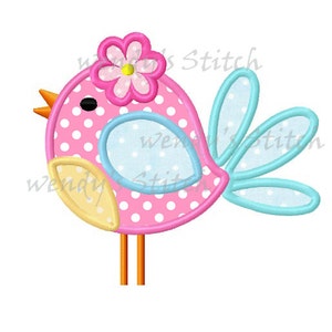 May include: A pink bird with white polka dots, a flower on its head, and blue and yellow accents. The bird has orange legs and beak. The image has the text "wendy's Stitch" in the background.