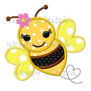May include: A yellow and black bee with a pink flower on its head. The bee has a smiling face and white polka dots on its body. The bee's wings are yellow with white polka dots.
