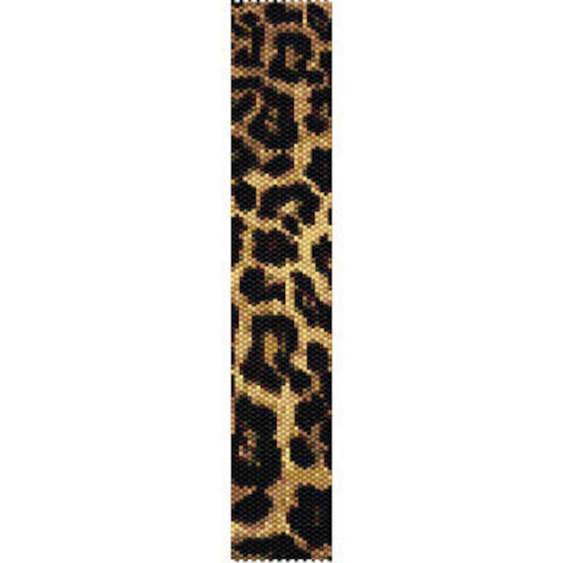May include: A rectangular strip of woven beadwork featuring a repeating leopard print pattern. The design consists of small, uniform beads in shades of black, tan, and golden brown, arranged to form the characteristic spots of a feline coat.