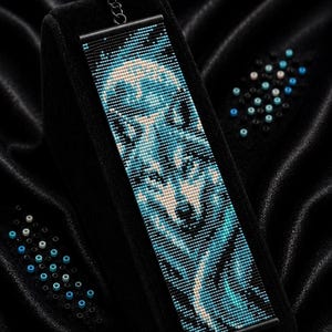May include: A rectangular beaded bracelet featuring a wolf head design in shades of blue, black, and white. The text Bracelet Bead Pattern, PDF, Instant Download, LOOM STITCH, Miyuki Delica 11/0, Color Chart, and Word Chart are visible.