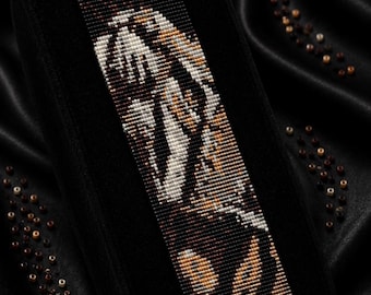 May include: A beaded bracelet pattern with a tiger-like design in shades of brown, white, and tan. The bracelet is displayed on a black velvet surface. Text on the image reads "Bracelet Bead Pattern" and "LOOM STITCH".