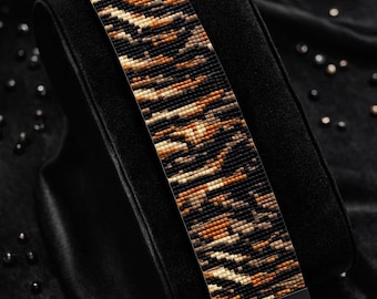 May include: A beaded bracelet pattern with a black and brown animal print design. The bracelet is displayed on a black velvet surface. The text "Bracelet Bead Pattern" and "PDF - Instant Download" are visible. The text "LOOM STITCH" and "Miyuki Delica 11/0" are also visible.