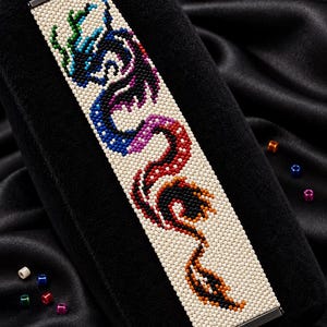 May include: A beaded bracelet featuring a dragon design in blue, purple, red, and orange on a cream background. The text reads Bracelet Bead Pattern, PEYOTE STITCH, Miyuki Delica 11/0, Color Chart, Word Chart, and Instant Download.