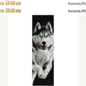 May include: A beaded pattern of a black and white husky dog with a red tongue. The pattern is on a black background.