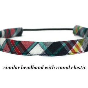 May include: A plaid headband with a black, red, green, and white pattern. The headband has a thin black elastic band.