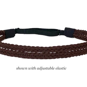 May include: A brown braided headband with an adjustable black elastic band. The headband is made of a woven material and is shown against a white background. The text "shown with adjustable elastic" is visible.