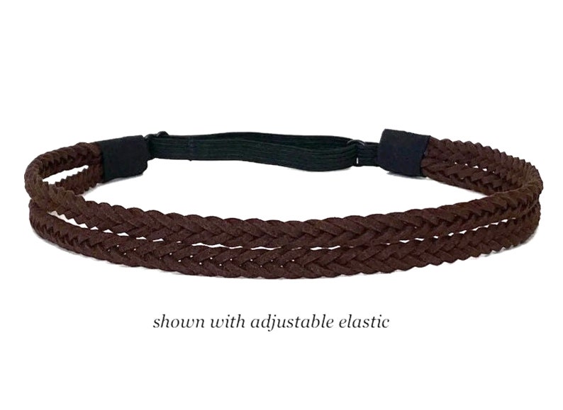 May include: A brown braided headband with an adjustable black elastic band. The headband is made of a woven material and is shown against a white background. The text "shown with adjustable elastic" is visible.