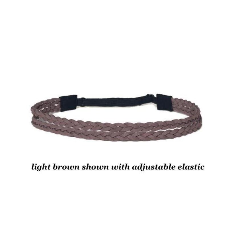 May include: A light brown braided headband with an adjustable black elastic band. The text "light brown shown with adjustable elastic" is below the headband.