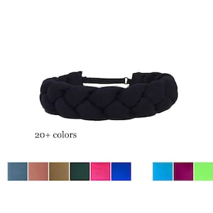May include: A black braided headband featuring a thick, woven fabric design with a thin elastic strap at the back for closure. Below the headband, the text 20+ colors is displayed, followed by a grid of small square color swatches.
