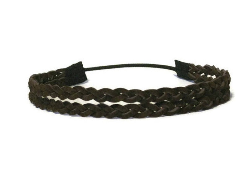 May include: A dark brown braided headband with a black elastic band. The headband features a double-braided design, with a soft, textured appearance. The accessory is designed for hair styling and fashion.