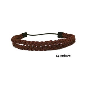May include: A brown braided headband with a black elastic band. The headband is made of a soft, woven material. The text "14 colors" is displayed below the headband.