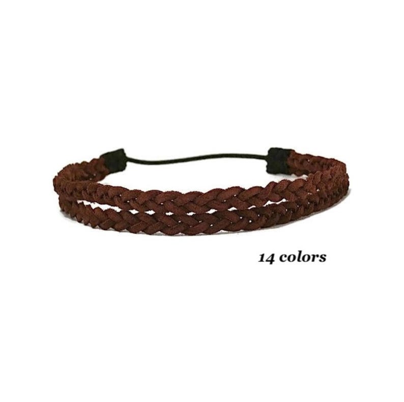 May include: A brown braided headband with a black elastic band. The headband is made of a soft, woven material. The text "14 colors" is displayed below the headband.