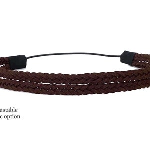 May include: A brown braided headband with an adjustable elastic band. The headband features a double-braided design in a rich, dark brown color. The text "Adjustable elastic option" is visible.