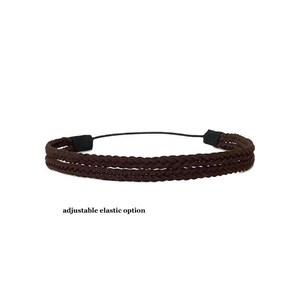 May include: A brown braided headband with an adjustable elastic option. The headband is made of a dark brown material and features a braided design. The text "adjustable elastic option" is below the headband.