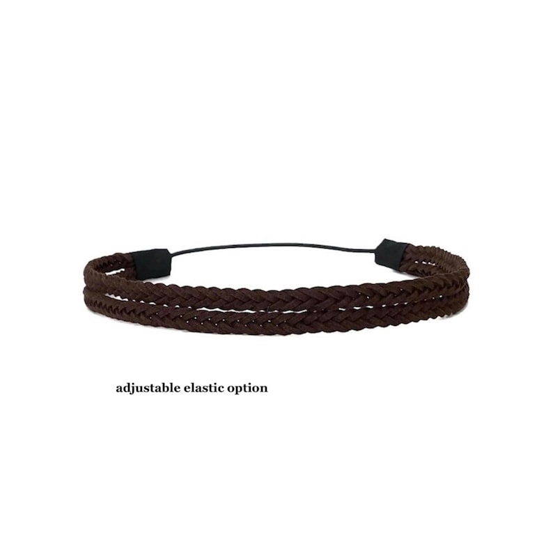 May include: A brown braided headband with an adjustable elastic option. The headband is made of a dark brown material and features a braided design. The text "adjustable elastic option" is below the headband.