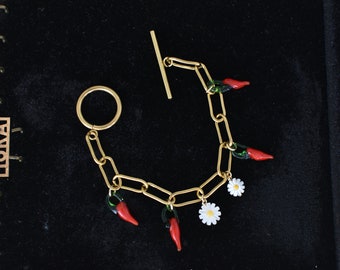 Bracelet doré, breloques piment rouge en verre et fleur marguerite en nacre, pâquerette