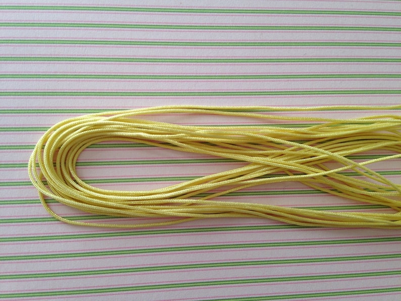 4meters thickness 0.7 mm polyester satin yarn pale yellow color