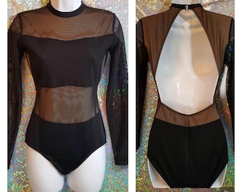 May include: Black long-sleeved bodysuit with a sheer mesh panel on the front and back. The bodysuit has a high neckline and a keyhole opening in the back.