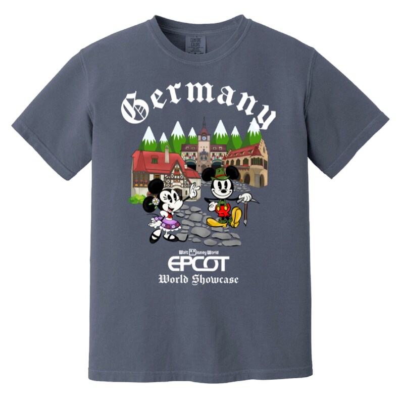 May include: A blue t-shirt with a white graphic of Mickey and Minnie Mouse in German attire in front of a German village. The text "Germany" is above the graphic and "Walt Disney World EPCOT World Showcase" is below the graphic.