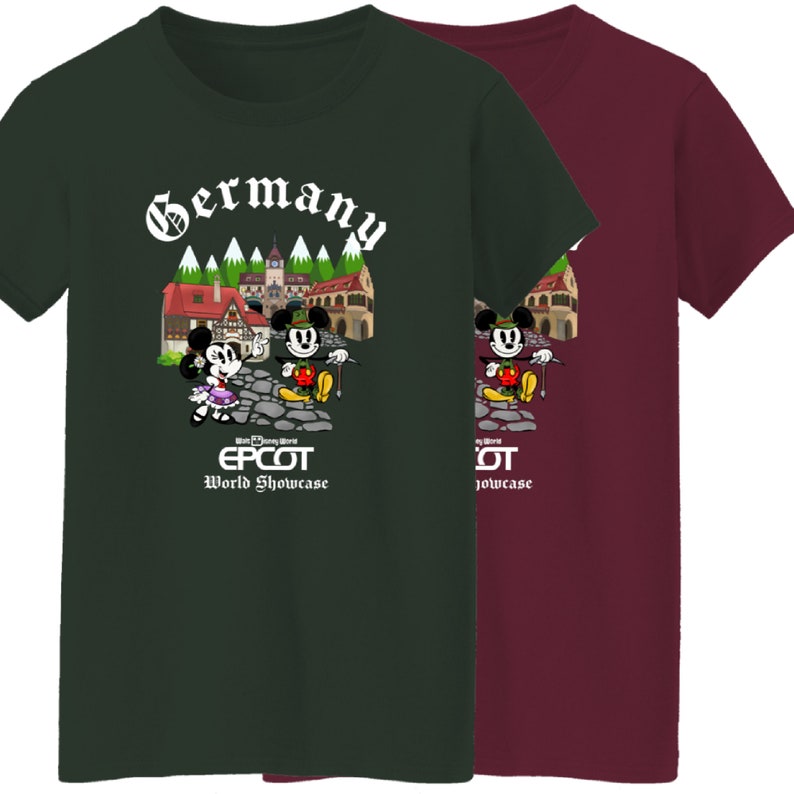May include: Two green and burgundy t-shirts featuring Mickey Mouse and Minnie Mouse in German attire. The shirts have a graphic of a German village with the text "Germany" and "EPCOT World Showcase".