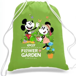 May include: Green drawstring bag with Mickey and Minnie Mouse gardening. The bag features the text "EPCOT INTERNATIONAL FLOWER & GARDEN FESTIVAL".