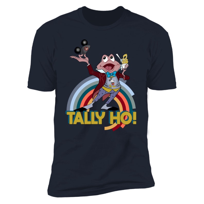 May include: Navy blue t-shirt with a cartoon frog juggling black balls and holding a dessert. The frog is wearing a red coat and a blue bow tie. The text "TALLY HO!" is below the frog, with a rainbow arc behind it.