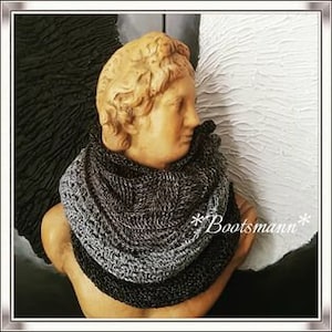 May include: A grey, black and charcoal grey infinity scarf made of crocheted yarn.