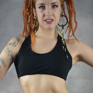​Front View (black ): Deep black and scoop neck yoga bra showing the supportive front fit and sleeveless artisanal design on a model