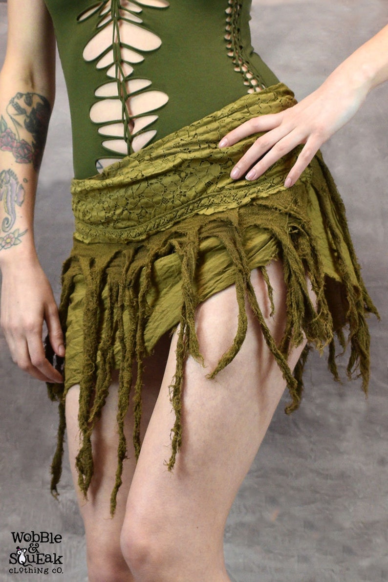 light yellow/green skirt with frayed edges and a tie closure. The skirt is made of a soft, lightweight fabric and has a flowy, bohemian style.